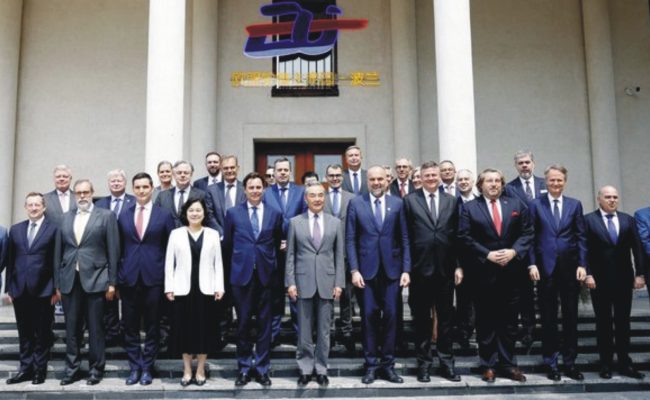 Chinese Foreign Minister Wang Yi speaking with EU diplomatic envoys at a formal meeting in Beijing.