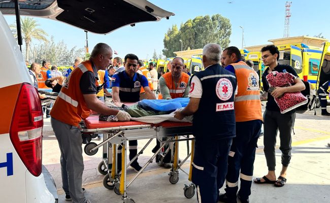 Egyptian paramedics transfer an injured Palestinian woman on the Egyptian side of the Rafah border crossing with the Gaza Strip, in the north eastern Sinai province, on November 7, 2023 amid ongoing battles between Israel and the Palestinian Hamas movement. (Photo by AFP) (Photo by -/AFP via Getty Images)